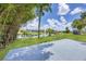 Waterfront property featuring a spacious grass backyard and views of the canal and docks at 6821 Marius Rd, North Port, FL 34287