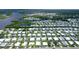 This is an aerial view of a manufactured home in a waterfront community with canals and a small lake at 738 Riverview Cir, North Port, FL 34287
