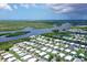 Wide aerial shot showcases a mobile home community near a river and marsh, highlighting its serene setting at 738 Riverview Cir, North Port, FL 34287