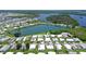 This is an aerial view of a manufactured home near a lake with many other homes in the waterfront community at 738 Riverview Cir, North Port, FL 34287