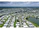 Panoramic aerial view of a vast mobile home community dotted with ponds and mature trees, offering a tranquil setting at 738 Riverview Cir, North Port, FL 34287