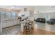 Open kitchen featuring a breakfast bar that connects seamlessly with the cozy living room at 738 Riverview Cir, North Port, FL 34287