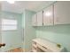 Well-lit laundry room with mint green walls and ample counter space at 738 Riverview Cir, North Port, FL 34287