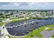 Scenic aerial view of marina with boats, docks, clubhouse, and surrounding residential community near lake at 738 Riverview Cir, North Port, FL 34287