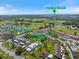Aerial view of community featuring lush landscaping, golf course, community pool, and Venice Beach at 751 Capri Isles Blvd # 108, Venice, FL 34292