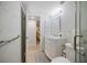 Bathroom featuring a vanity with drawers, a patterned wall, and a view into an adjacent room at 751 Capri Isles Blvd # 108, Venice, FL 34292