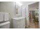 Bathroom with vanity, decorative mirror, and view to bedroom at 751 Capri Isles Blvd # 108, Venice, FL 34292