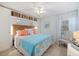 Coastal-themed bedroom with decorative pillows, wicker headboard, and built-in storage at 751 Capri Isles Blvd # 108, Venice, FL 34292