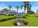 Community sign 'Capri Village East' with palm trees, lush lawns, and tropical plants at 751 Capri Isles Blvd # 108, Venice, FL 34292