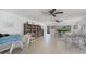 Bright community room for all with tile floors, bookcase, table and chairs at 751 Capri Isles Blvd # 108, Venice, FL 34292