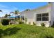 A serene backyard featuring a cozy patio, lush green lawn, and tasteful landscaping for relaxing and outdoor enjoyment at 751 Capri Isles Blvd # 108, Venice, FL 34292
