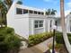 Charming home with modern architectural details, manicured landscaping, and a well-lit walkway to the entrance at 751 Capri Isles Blvd # 108, Venice, FL 34292