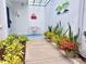Inviting front patio area featuring a bench, plants and colorful decor at 751 Capri Isles Blvd # 108, Venice, FL 34292