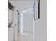 Hallway with washer and dryer includes white paint and access to entryway and closet at 751 Capri Isles Blvd # 108, Venice, FL 34292