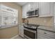 Updated kitchen features stainless steel appliances and granite countertops at 751 Capri Isles Blvd # 108, Venice, FL 34292