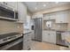 This kitchen features granite counters, stainless steel appliances, and white cabinetry at 751 Capri Isles Blvd # 108, Venice, FL 34292