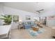Cozy living room featuring bright furniture, neutral walls and an adjacent patio door at 751 Capri Isles Blvd # 108, Venice, FL 34292