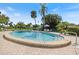Enjoy the Florida lifestyle with this community pool, featuring comfortable seating and lush landscaping at 751 Capri Isles Blvd # 108, Venice, FL 34292