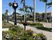 Charming street view with beautifully landscaped sidewalks and a classic clock tower at 751 Capri Isles Blvd # 108, Venice, FL 34292