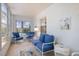 Bright sunroom with blue cushioned seating and tiled floor, perfect for relaxing at 751 Capri Isles Blvd # 108, Venice, FL 34292