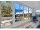Sunroom featuring large windows, blue seating, and a clear view of the outdoors at 751 Capri Isles Blvd # 108, Venice, FL 34292