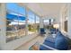 Sunroom with views of the outside and blue cushioned seating, providing a relaxing space at 751 Capri Isles Blvd # 108, Venice, FL 34292
