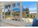 Sunroom featuring views of the outside, blue seating, and patio table at 751 Capri Isles Blvd # 108, Venice, FL 34292
