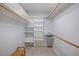 Walk-in closet with shelving and wooden rods for ample storage at 751 Capri Isles Blvd # 108, Venice, FL 34292