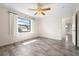 Simple bedroom featuring laminate wood flooring and a large window at 844 Senda Plata # 27, Venice, FL 34293