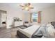 Bedroom featuring neutral walls, a gray bed, wood-look flooring, and a window at 844 Senda Plata # 27, Venice, FL 34293