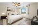 Bright bedroom featuring a ceiling fan and a large window letting in natural light at 844 Senda Plata # 27, Venice, FL 34293