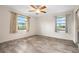 Bedroom with a ceiling fan, two windows, and light-colored wood-look flooring at 844 Senda Plata # 27, Venice, FL 34293