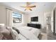 Cozy bedroom features a plush bed and a sleek entertainment center at 844 Senda Plata # 27, Venice, FL 34293