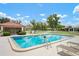 Relaxing community pool showcasing lounge seating, mature trees, and a covered gathering area at 844 Senda Plata # 27, Venice, FL 34293