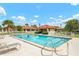 Inviting community pool area with lounge chairs and beautiful views of the surrounding neighborhood at 844 Senda Plata # 27, Venice, FL 34293