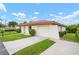 Well-kept single-story home showcasing an attached garage, red tile roof, and inviting driveway at 844 Senda Plata # 27, Venice, FL 34293