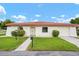 Charming single-story home featuring a red tile roof, well-maintained landscaping, and attached garage at 844 Senda Plata # 27, Venice, FL 34293