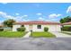 Charming single-story home featuring a red tile roof, well-manicured lawn, and attached garage at 844 Senda Plata # 27, Venice, FL 34293