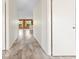 Hallway with modern wood-look flooring leading to a living space with natural light at 844 Senda Plata # 27, Venice, FL 34293
