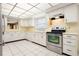 The kitchen features white cabinets, stainless steel appliances, and a window for natural light at 844 Senda Plata # 27, Venice, FL 34293