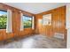 Wood-paneled sitting room bathed in natural light, showcasing tranquil views and modern finishes at 844 Senda Plata # 27, Venice, FL 34293