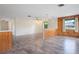 Bright open-concept room featuring vinyl floors and wood-paneled accent walls with two pendant lights at 844 Senda Plata # 27, Venice, FL 34293