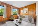 Wood-paneled sitting room bathed in natural light, showcasing tranquil views and modern finishes at 844 Senda Plata # 27, Venice, FL 34293