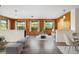 Bright living room with wood paneled accent wall, updated ceiling fan, and views of the surrounding landscape at 844 Senda Plata # 27, Venice, FL 34293