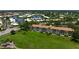 Aerial view of the condominium complex shows it ideally situated near a golf course and water with lush surrounding trees at 849 Wexford Blvd # 849, Venice, FL 34293