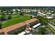Aerial shows the condo near golf course, lakes, many trees and greenery, parking and other condominium complexes at 849 Wexford Blvd # 849, Venice, FL 34293