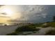 Picturesque beach view with lush dune vegetation, perfect for a serene coastal lifestyle at 849 Wexford Blvd # 849, Venice, FL 34293