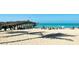 Picturesque beach scene with a pier and beachgoers enjoying the sun, showcasing the waterfront lifestyle at 849 Wexford Blvd # 849, Venice, FL 34293