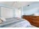 Bedroom boasts ample closet space, wood furniture, and calming light-blue walls at 849 Wexford Blvd # 849, Venice, FL 34293