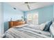 Bright bedroom featuring a large window with natural light, light-blue walls, and matching wood furniture at 849 Wexford Blvd # 849, Venice, FL 34293